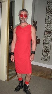 A picture of a bearded man wearing a red dress.