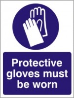 A sign warns gifted adults to wear gloves when dealing with their own trash